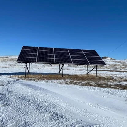 Ground-mounted solar array in a snowy field